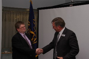 Col. John Kirby (Ret.) (r), chapter president, thanks Ian Bryant of the Defence Security Standards Organisation, U.K. Ministry of Defence, for his talk at the November meeting.